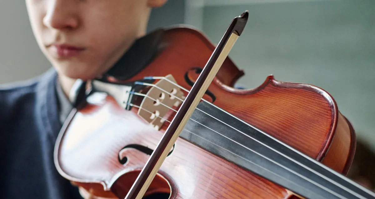 Closeup of a boy playing the violin